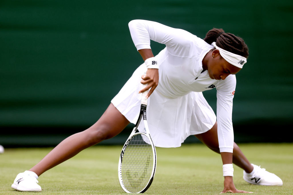 Coco Gauff steadies herself as she slips during her first-round match at Wimbledon