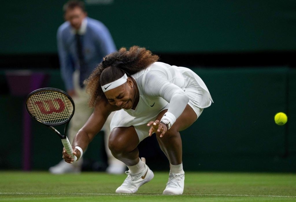 Serena Williams cries in pain as she falls to the ground during her first-round match at Wimbledon.