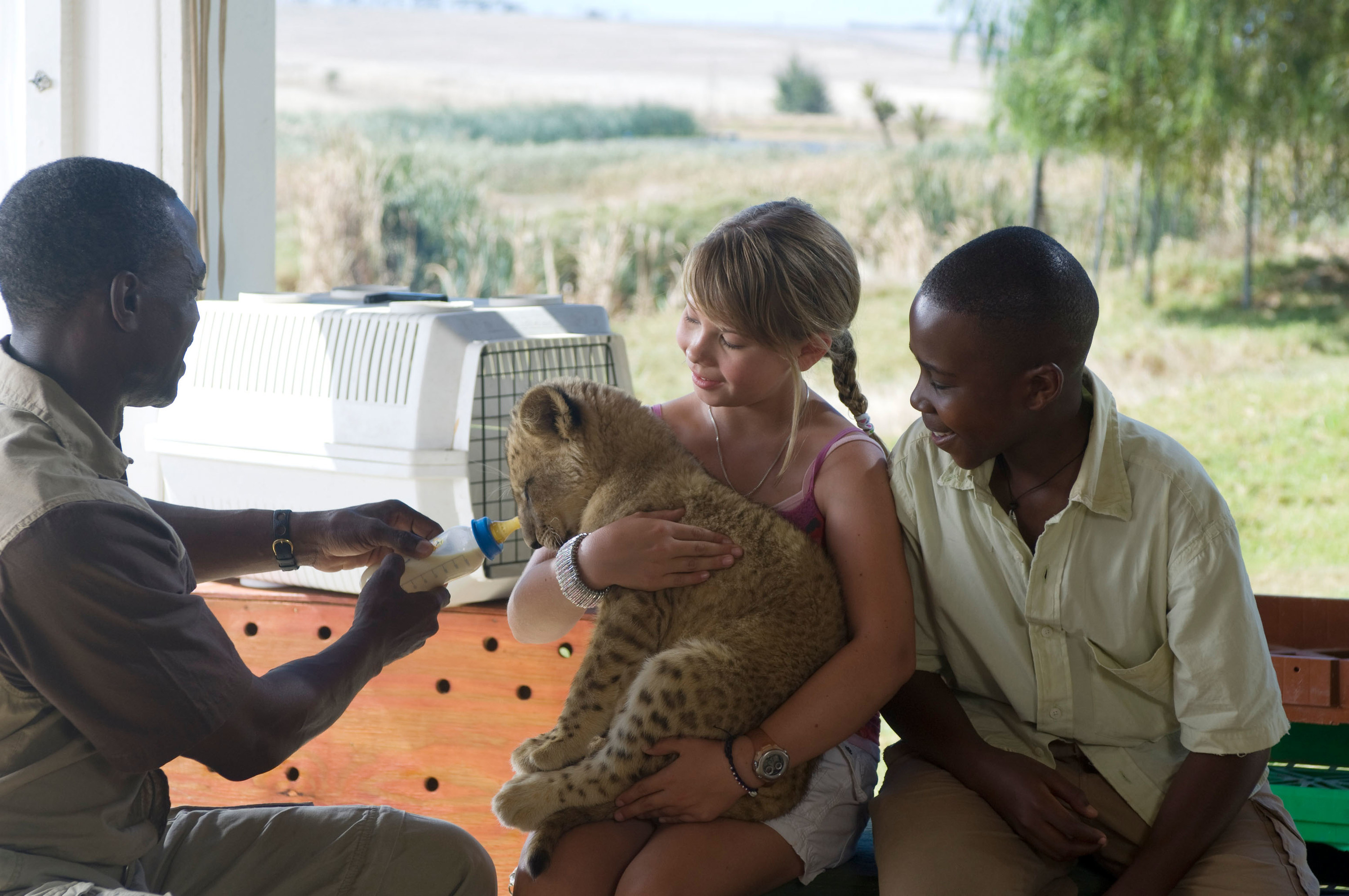 Getmore Sithole, Bindi Irwin, and Siyabulela Ramba pose with a baby tiger on set of &quot;Free Willy: Escape from Pirate&#x27;s Cove&quot;