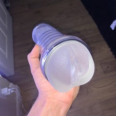 Model holding masturbator to display front and full length