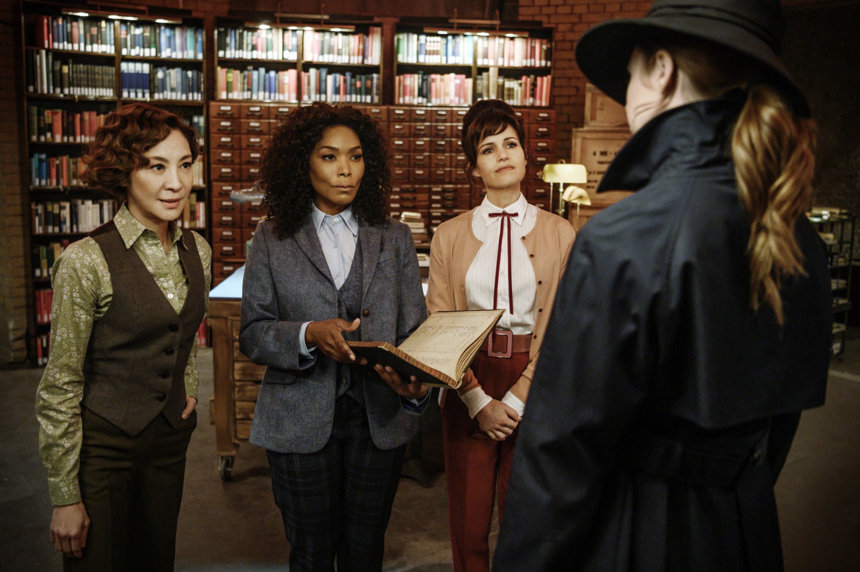 from left is Michelle Yeoh, Angela Bassett, Carla Gugino, and Karen Gillan in a library