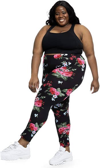 Model wearing floral black leggings