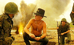 Robert Duvall in &quot;Apocalypse Now&quot; during the &quot;smell of napalm in the morning&quot; scene: A topless Army officer wearing a hat sits coolly while his two soldiers react to a blast behind him