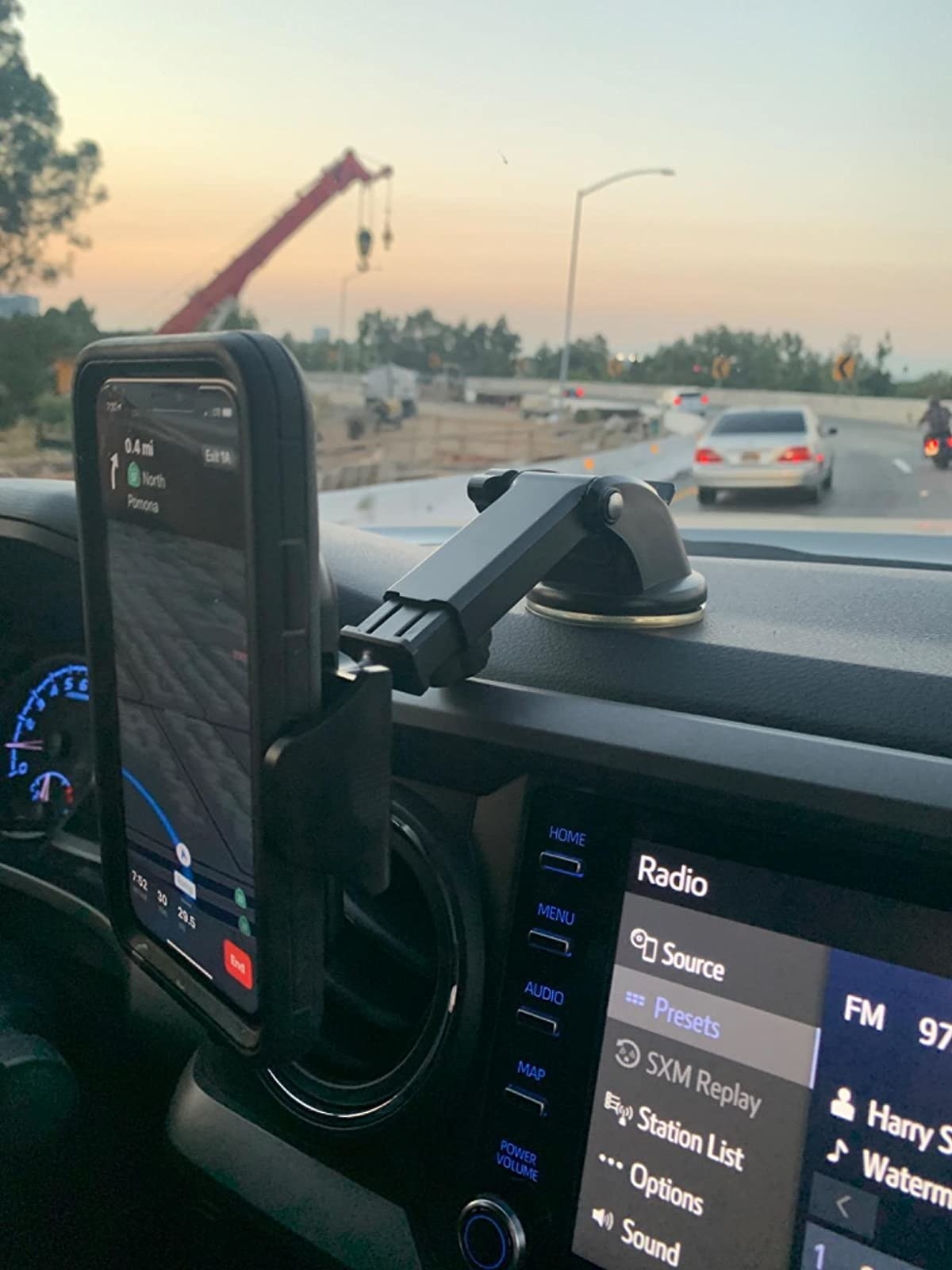 reviewer image of the VICSEED car mount mounted to the top of the dashboard