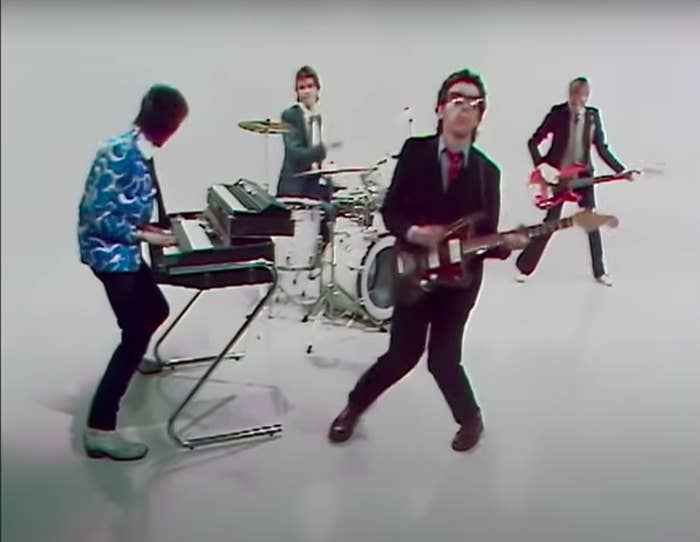 A still from the music video for &quot;Pump it Up&quot; showing Elvis and his band performing