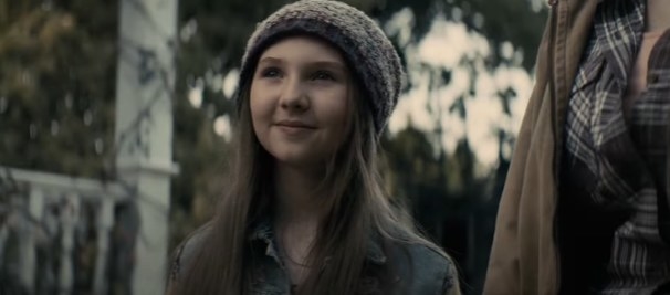 Young girl smiling while wearing a beanie