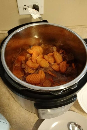 a reviewer photo of the open instant pot with homemade soup inside 