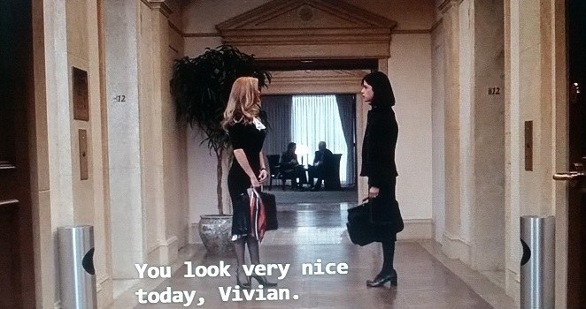 Elle and Vivian stare at each other in the hallway