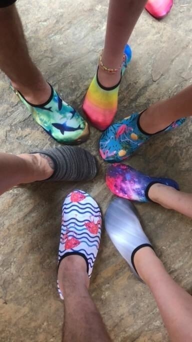 Reviewer's photograph  showing the full   household  wearing the aqua socks successful  antithetic  prints