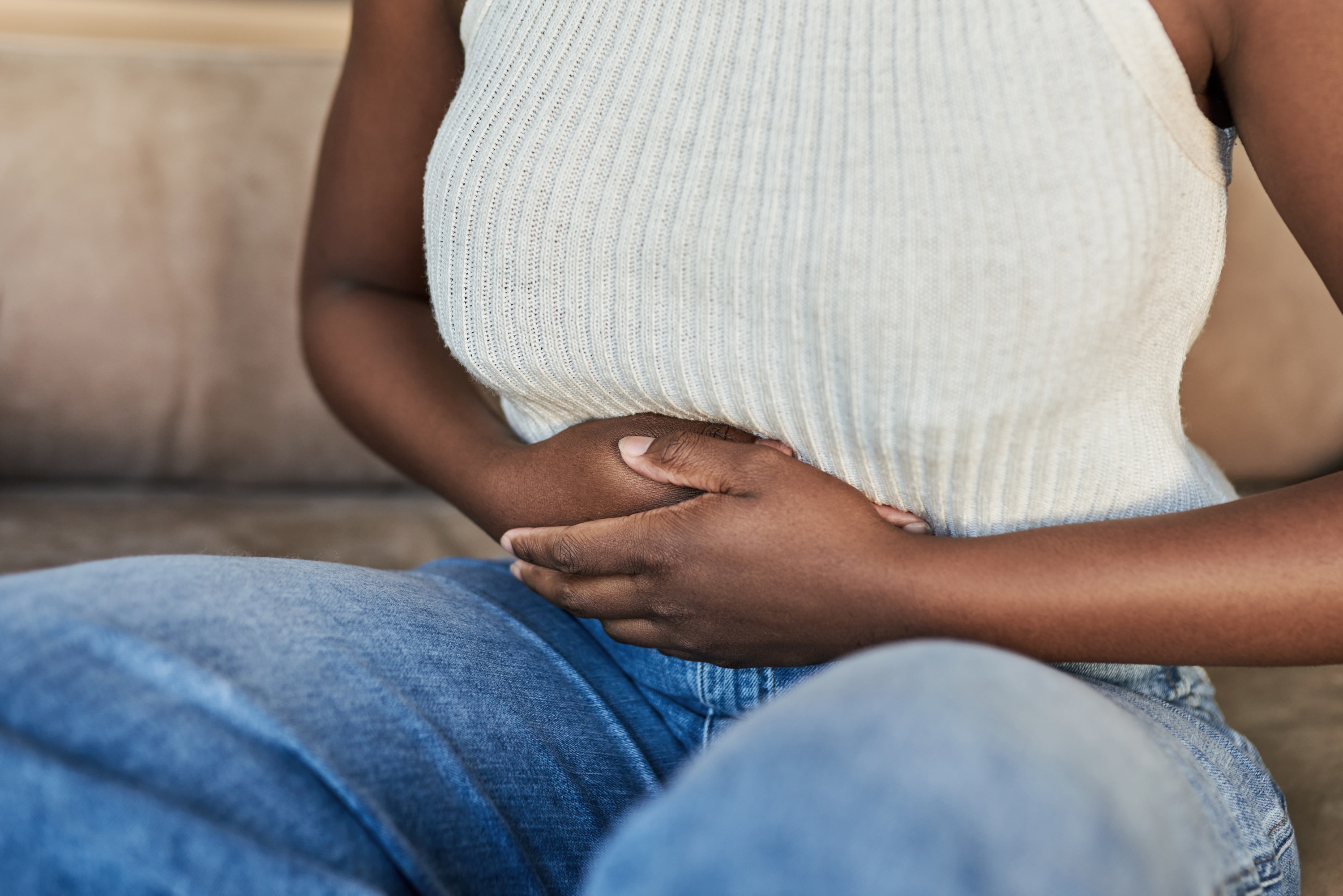 An image of a woman clutching her abdomen in pain