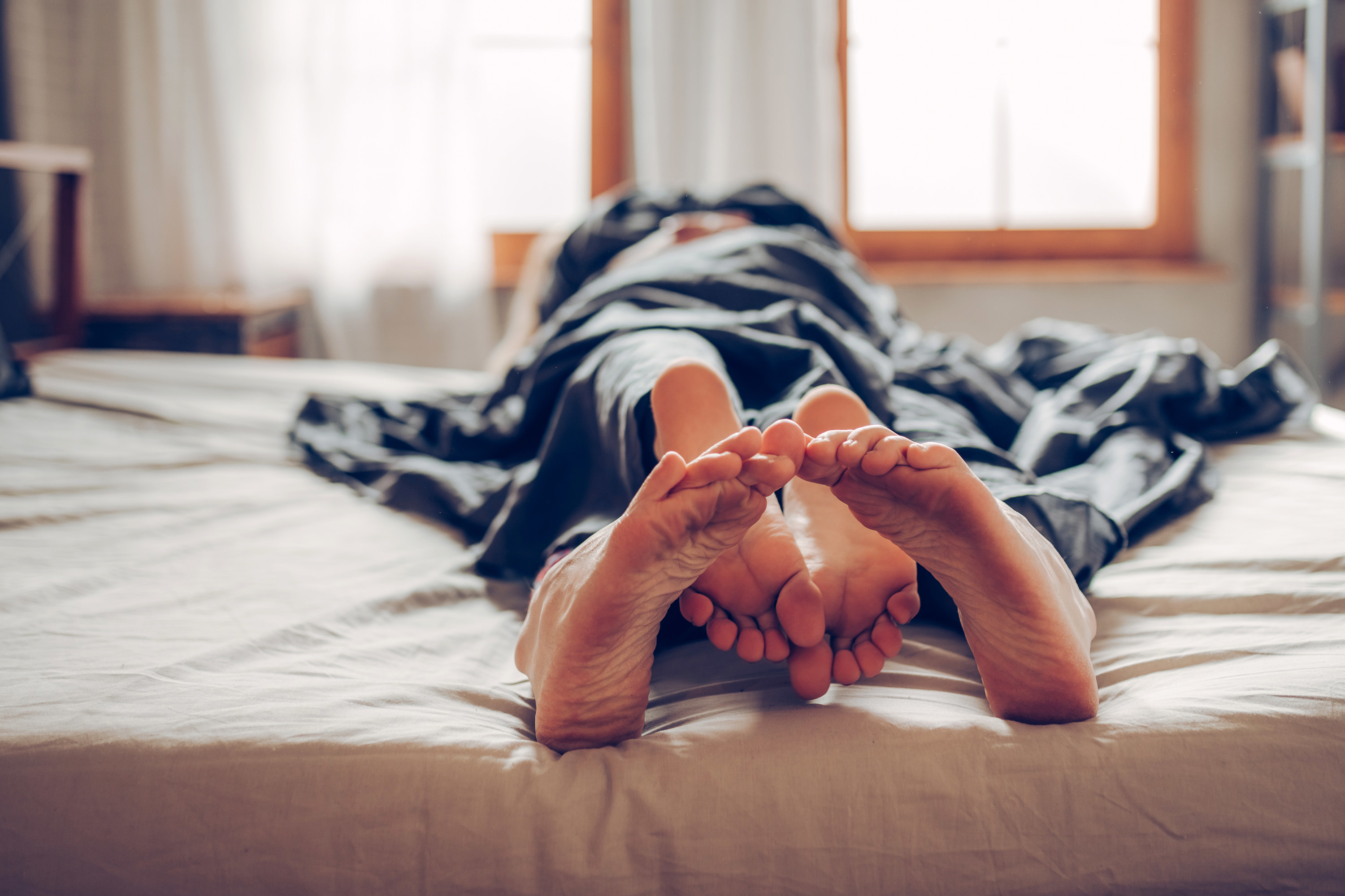 An image of a couple entangled in sheets