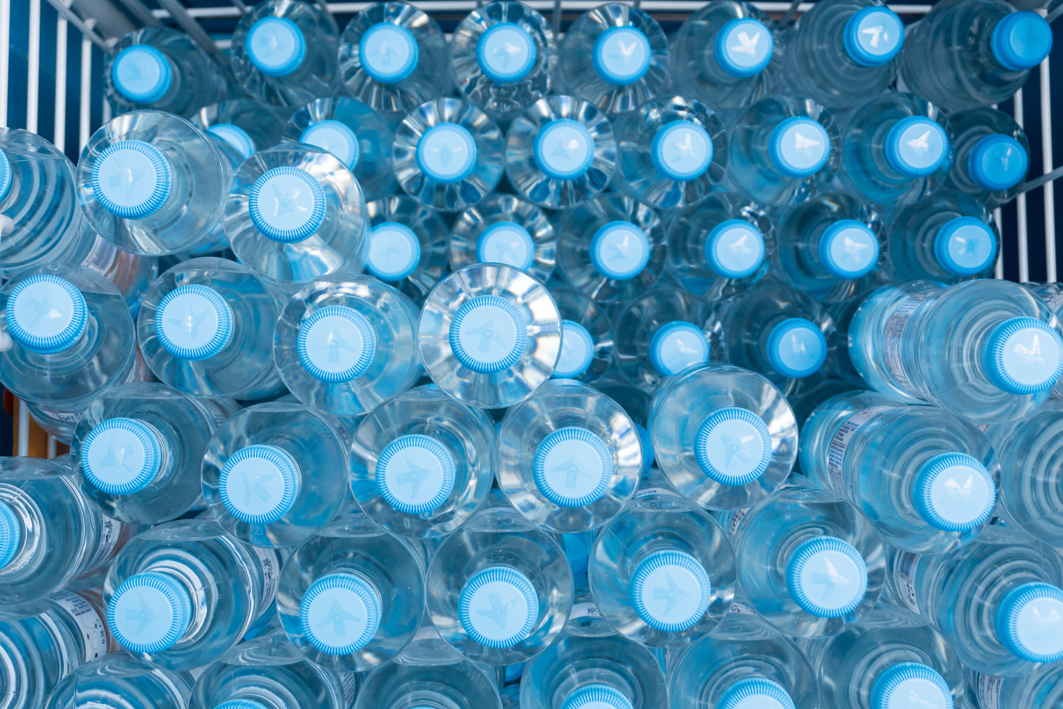 Dozens of plastic waters bottles stacked up