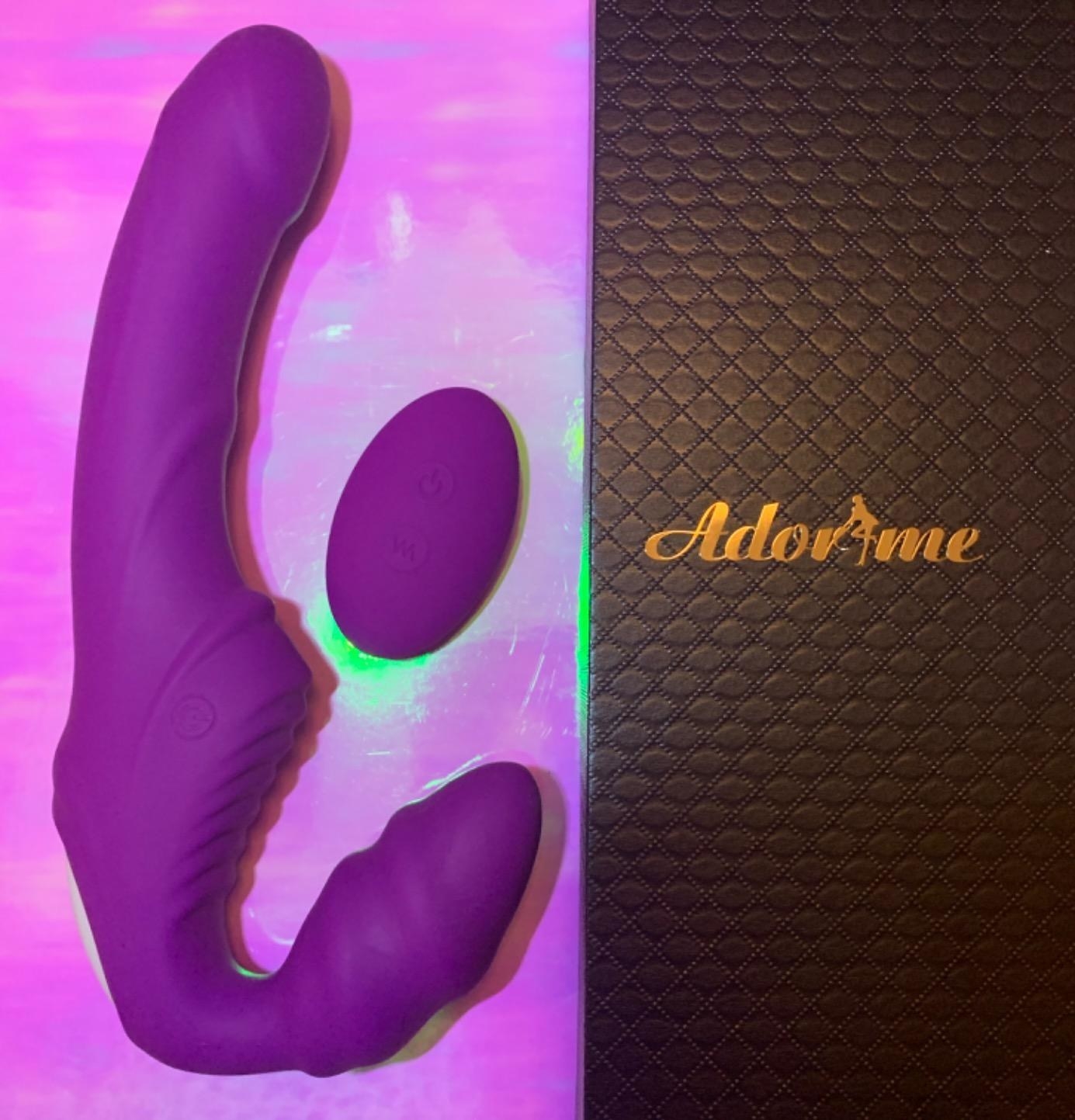 Purple vibrating strap-on and remote next to box