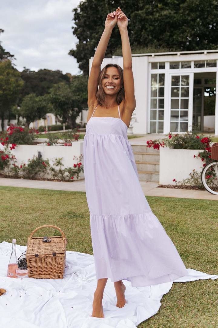 a model wearing a lavender maxi dress while at a picnic