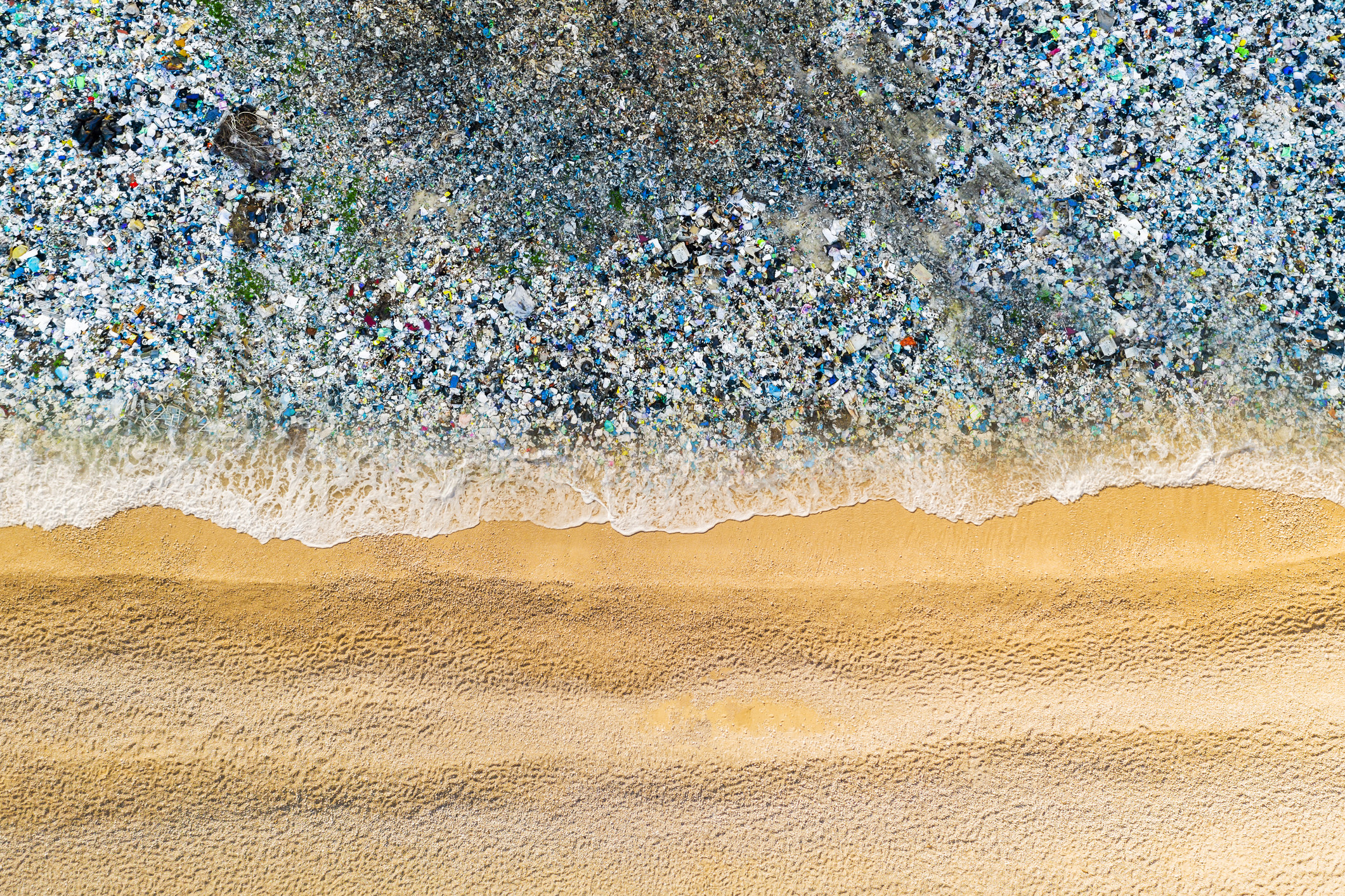 An image of trash washing up in the ocean