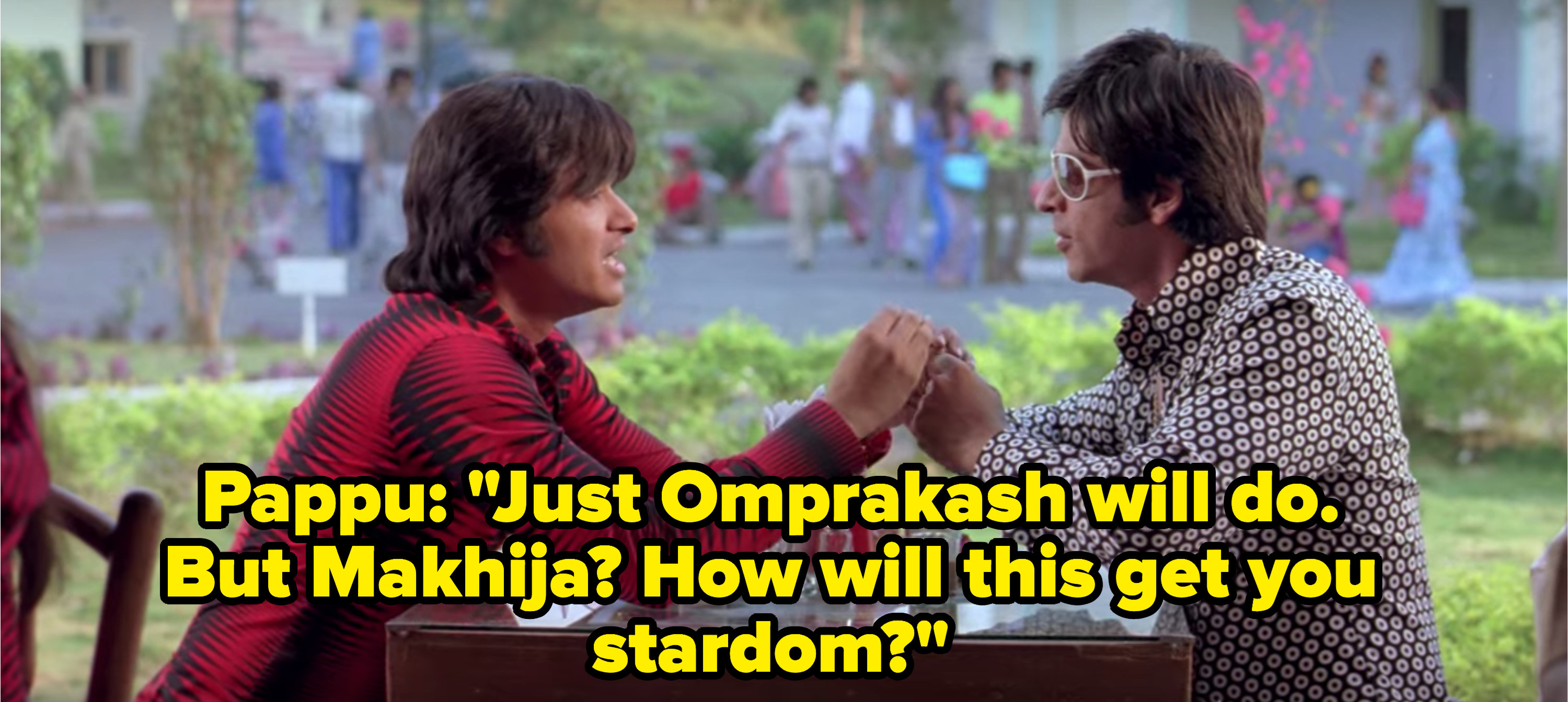 Om and Pappu sit together at a small cafe table.