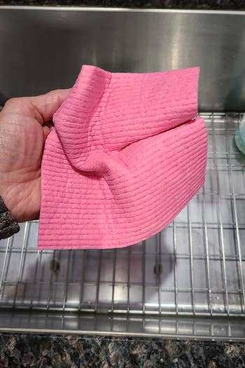 a reviewer photo of a hand holding a wet dishcloth 