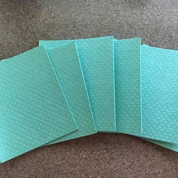 a reviewer photo of the fanned out dishcloths 
