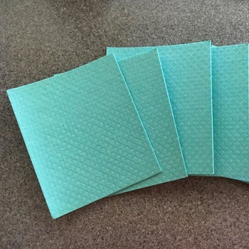 a reviewer photo of the fanned out dishcloths 