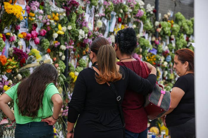 People visit the vigil for those missing in the Surfside condo collapse.