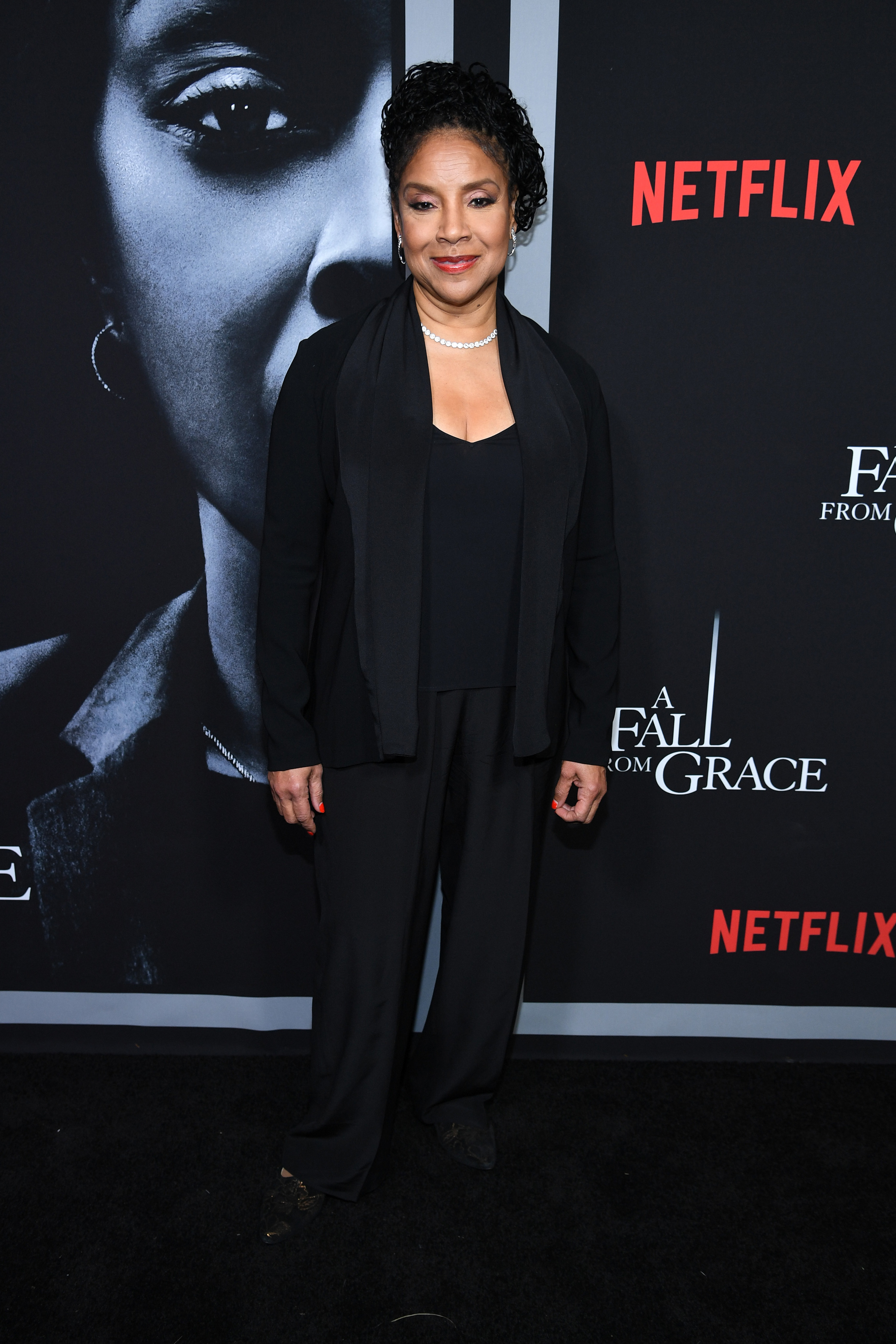 Rashad wears a blouse, blazer, and pants at a red carpet event in 2020