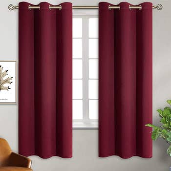 Burgundy blackout curtains placed on window