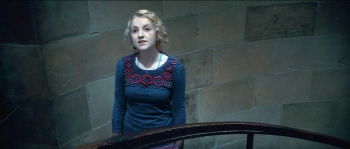 Evanna Lynch stands on a stairwell in Harry Potter and the Deathly Hollows Part Two