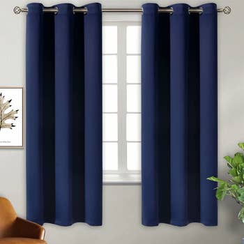 Navy blue blackout curtains placed on window