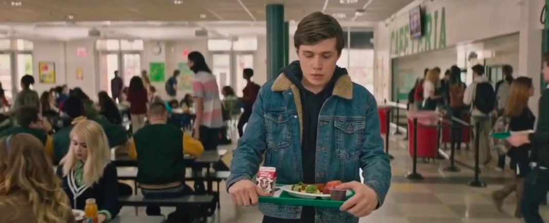 Simon carries a tray of food through the cafeteria in Love, SImon