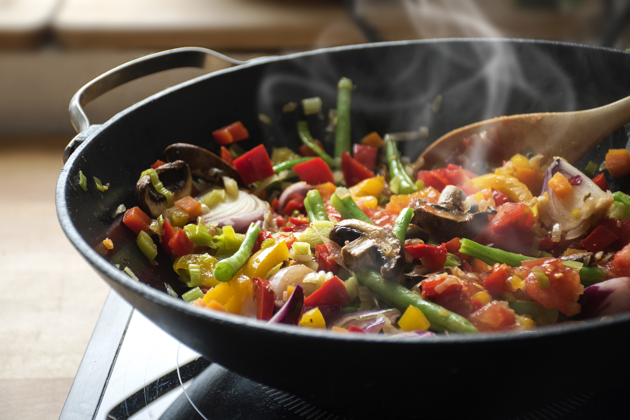 Making stir fry vegetables in a wok.