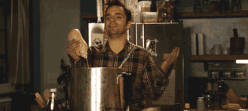 Nick from New Girl pouring mustard into a stock pot.
