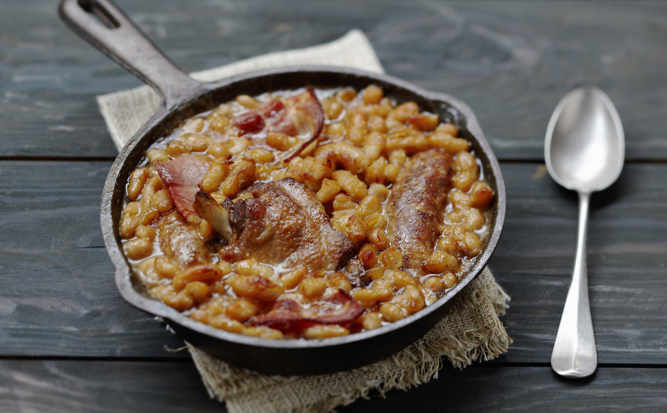 Homemade cassoulet in a small cast iron skillet.