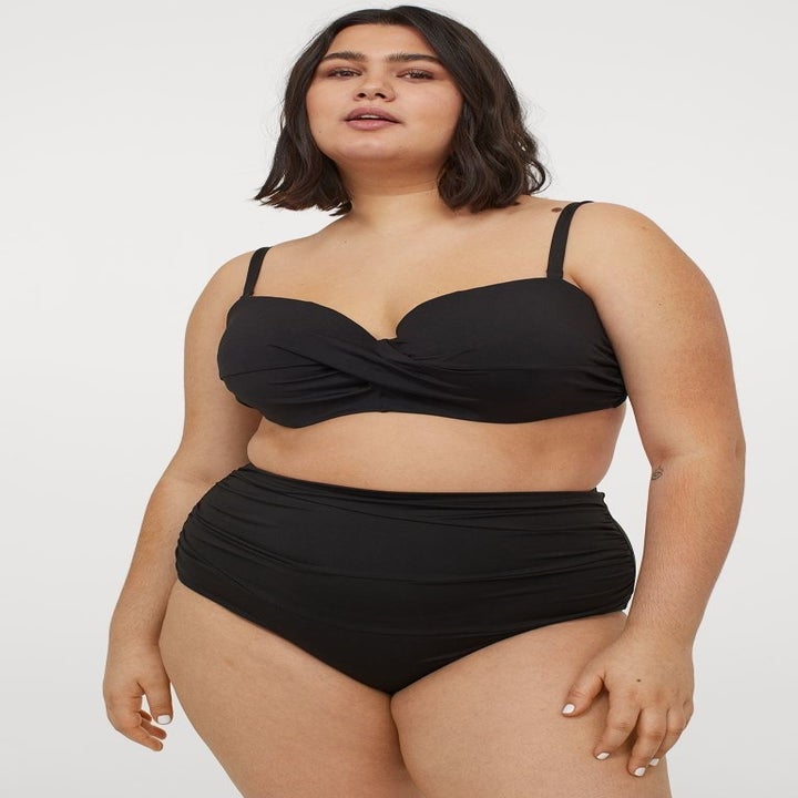 model wearing black bikini set with high-waisted bottoms