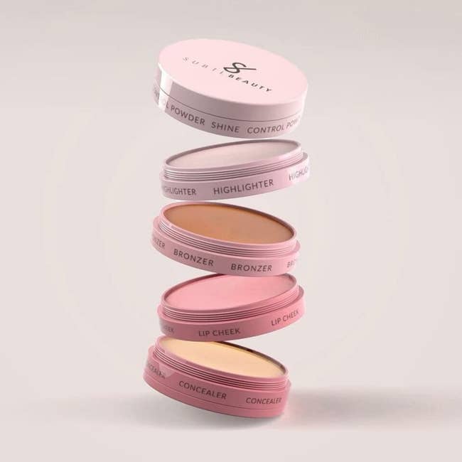 concelear, lip cheek, bronzer, highlighter, and shine control powder in a stack