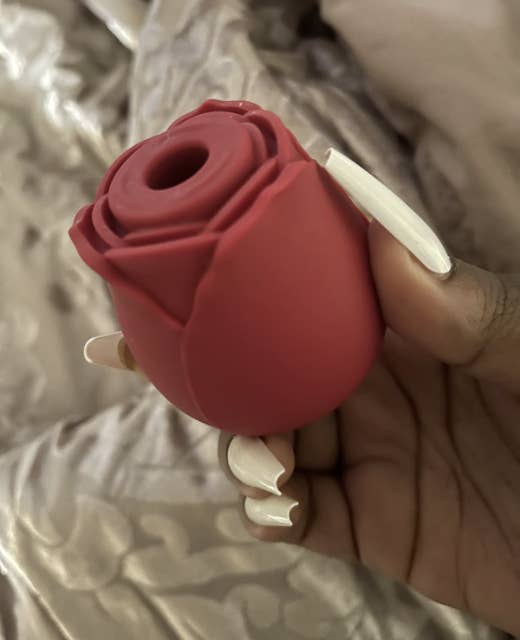 Red rose-shaped suction vibrator