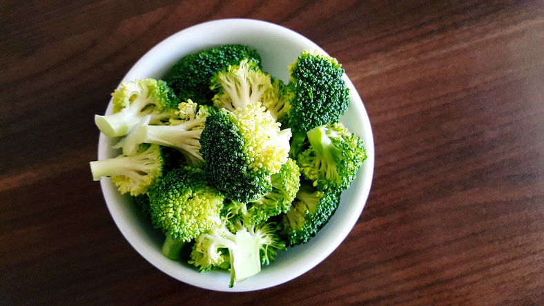 broccoli in a white bowl on a table