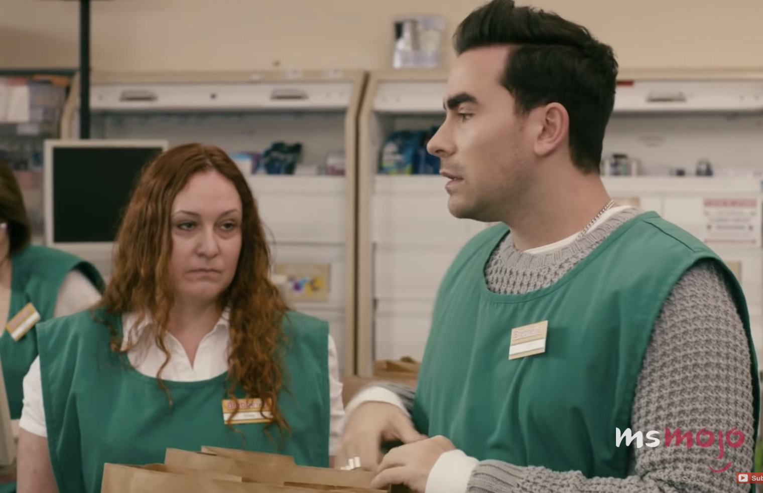 Man and woman bagging groceries