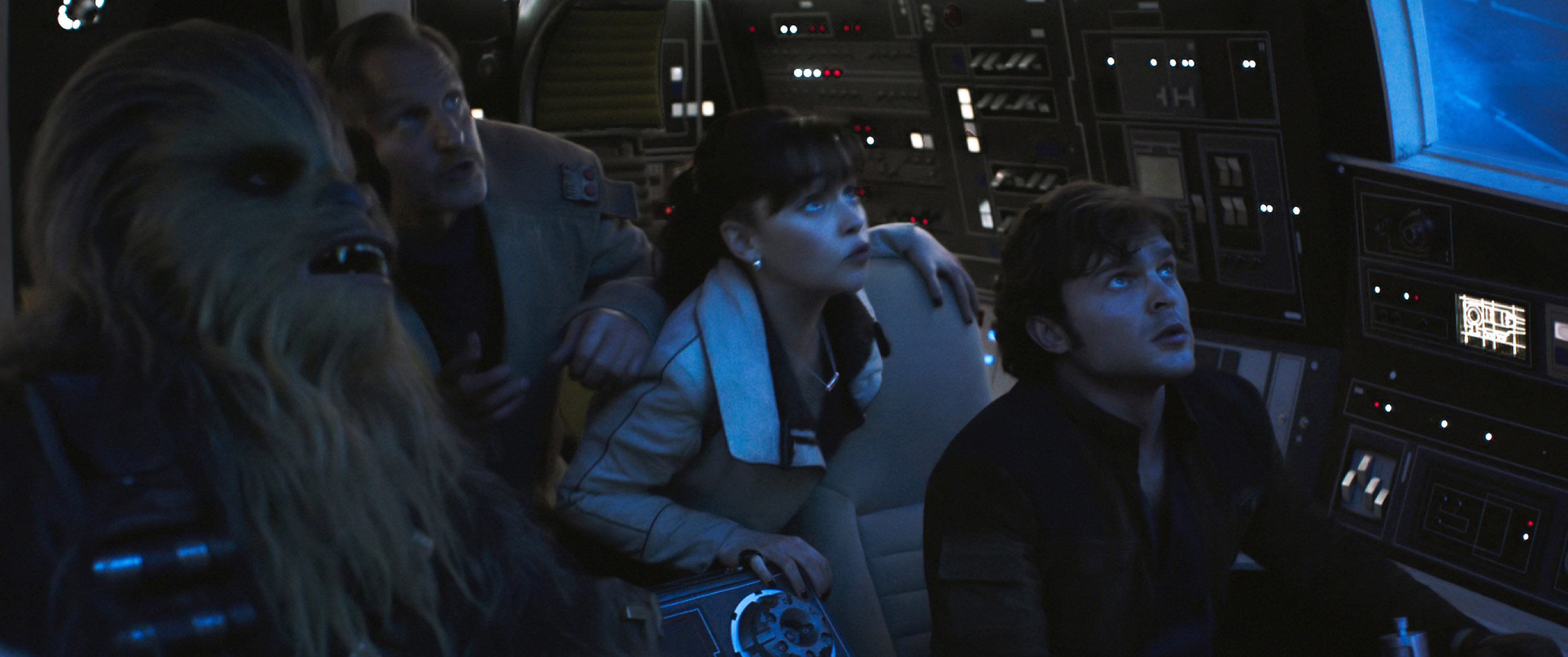 Left to right, Joonas Suotamo as Chewbacca, Woody Harrelson as Beckett, Emilia Clarke as Qi’ra, Alden Ehrenreich as Han Solo stare off-screen in &quot;Solo: A Star Wars Story&quot;