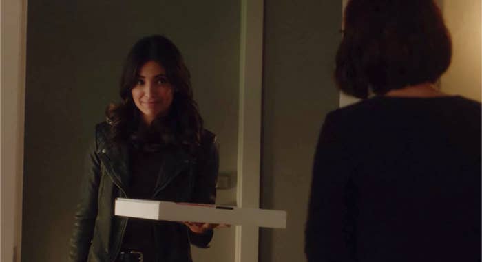 Maggie Sawyer stands in Alex Danvers&#x27; doorway in a leather jacket holding a pizza box.