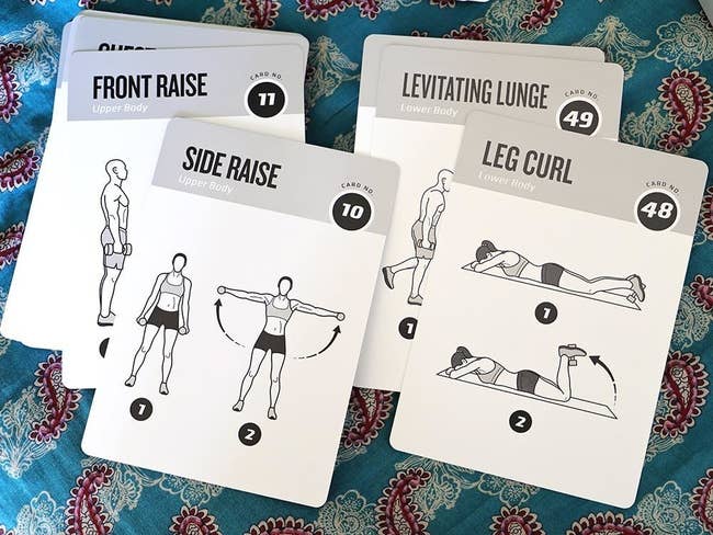 a reviewer photo of a few of the exercise cards showing how to do the leg curl and a side raise with a dumbbell