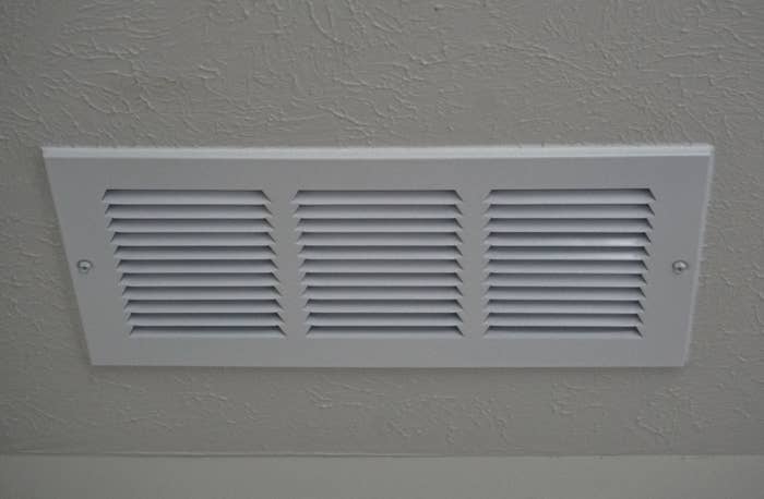 A central air register in a home&#x27;s ceiling