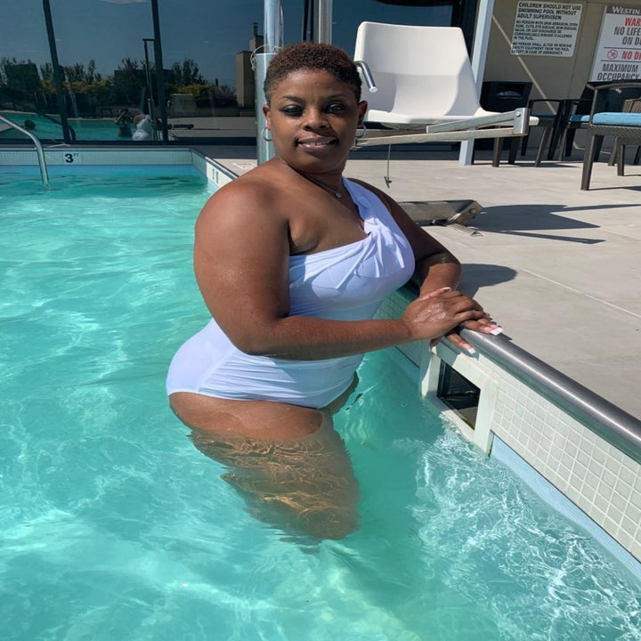 Reviewer wearing white bathing suit in pool