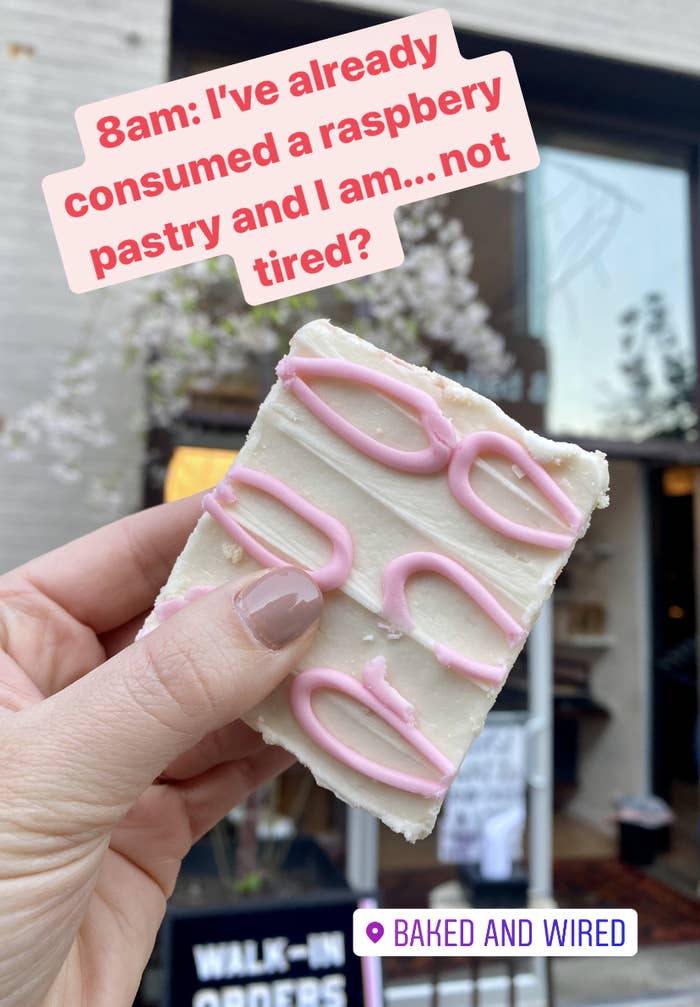 hand holding raspberry pastry with text 8am: I've already consumed a raspberry pastry and am not tired