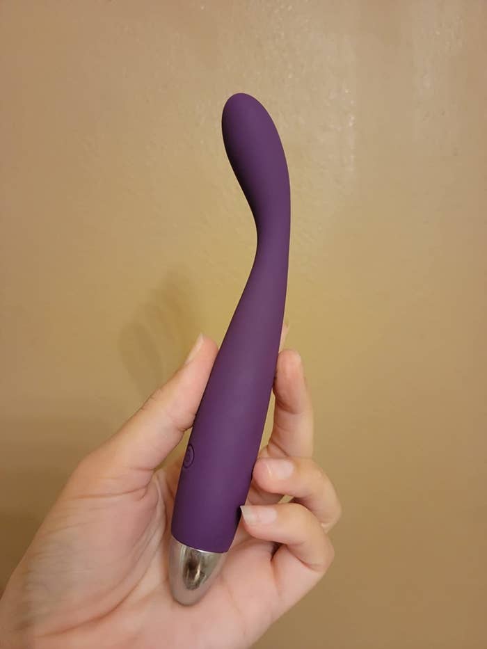 Slim purple vibrator with curved tip