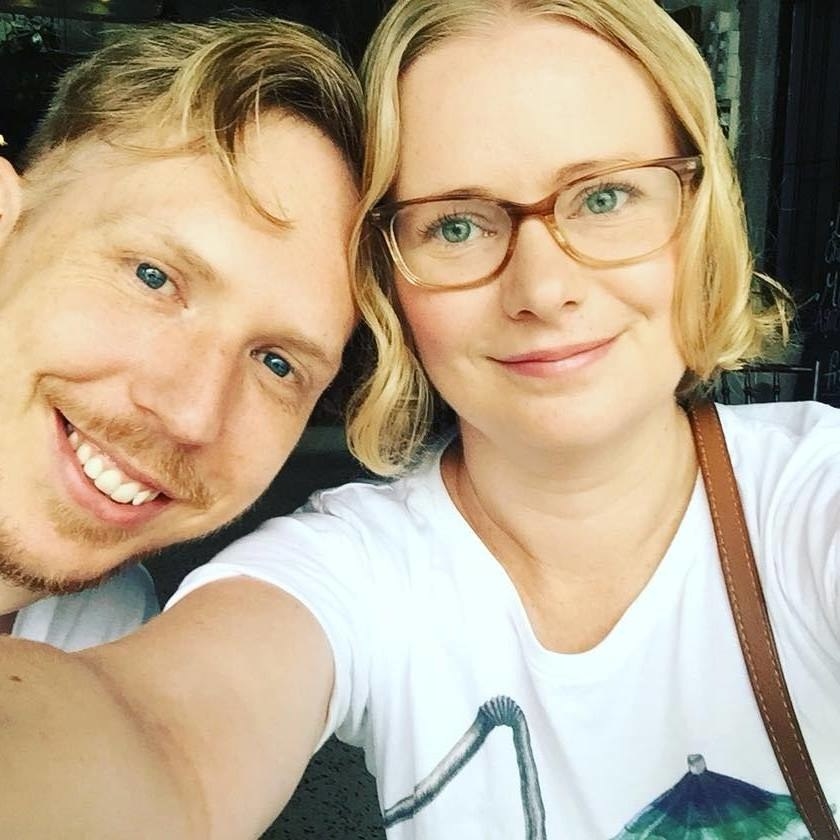 Erin posing in glasses with her husband