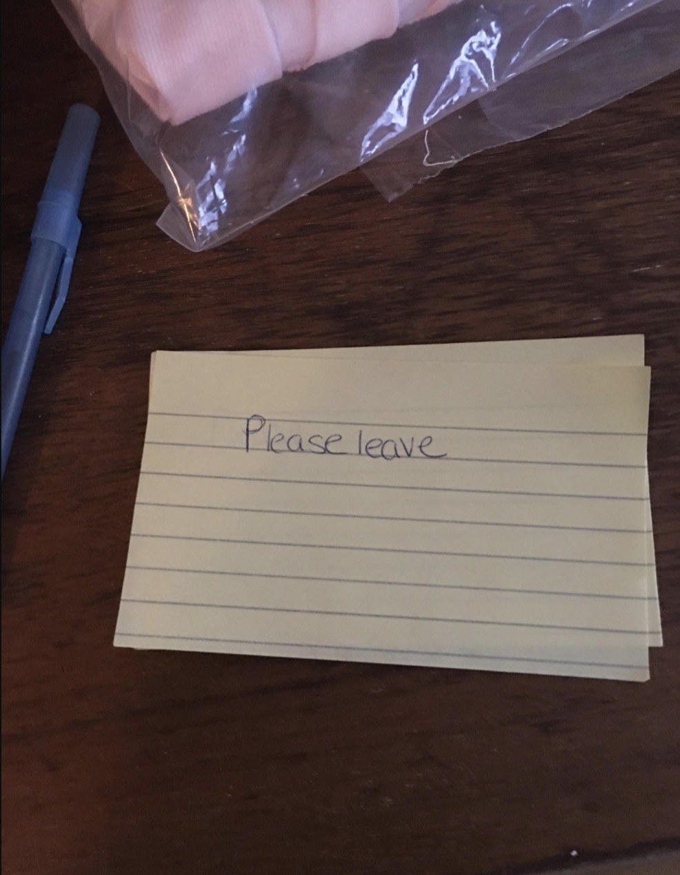 A note card with just &quot;Please leave&quot; on it