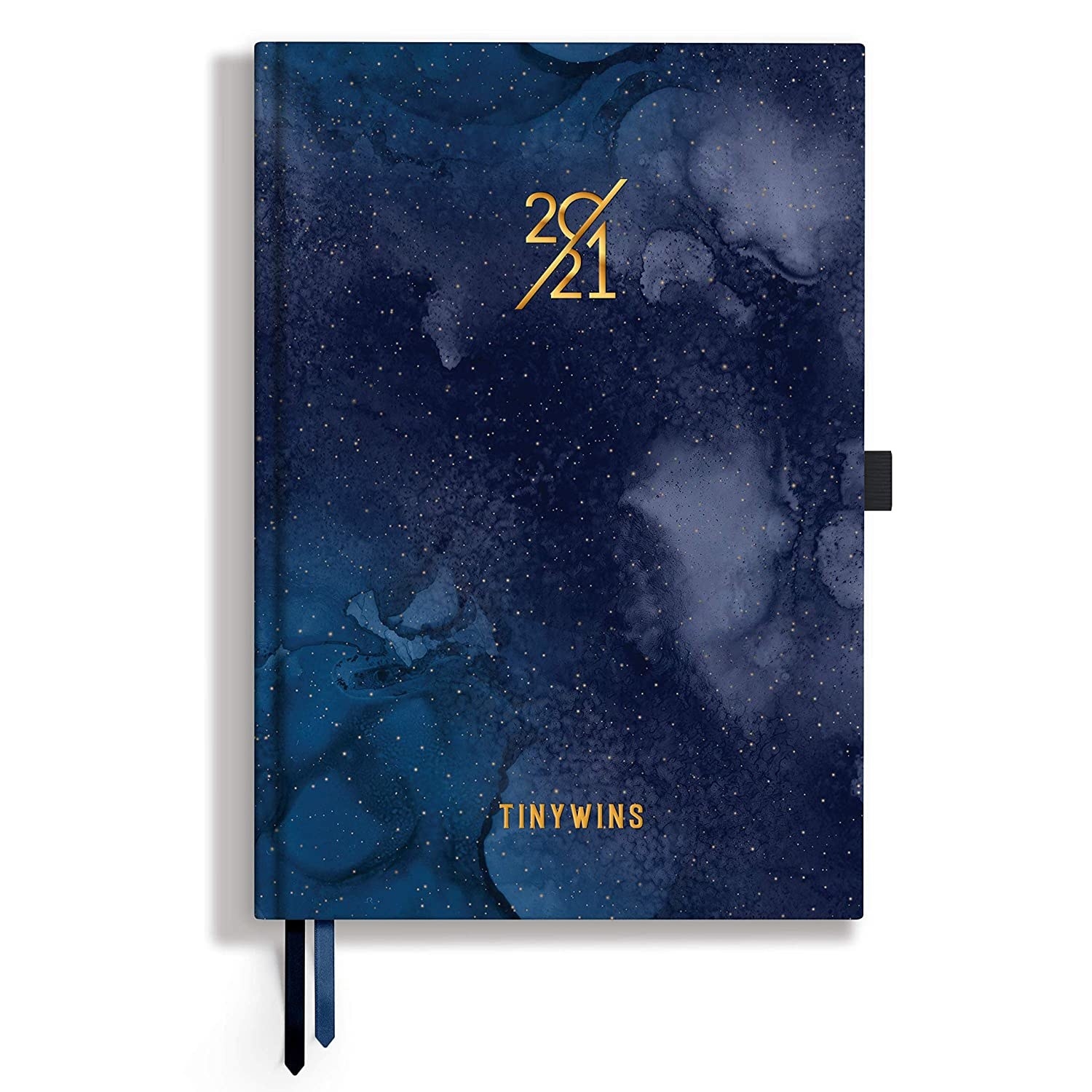 A navy blue planner with a night sky like pattern and white speckles on it. It has the text 2021 and Tiny Wins embossed in gold on it.