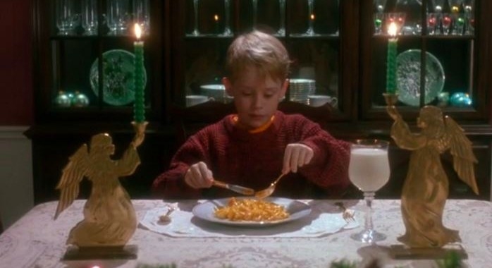 Kevin sits at the dinner table with food and a glass of milk