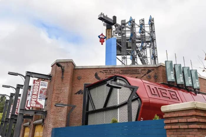 Spider-Man hangs atop the outside of the new Spider-Man ride