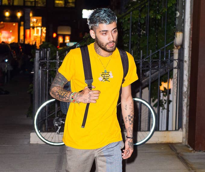 Zayn with a backpack walking outside